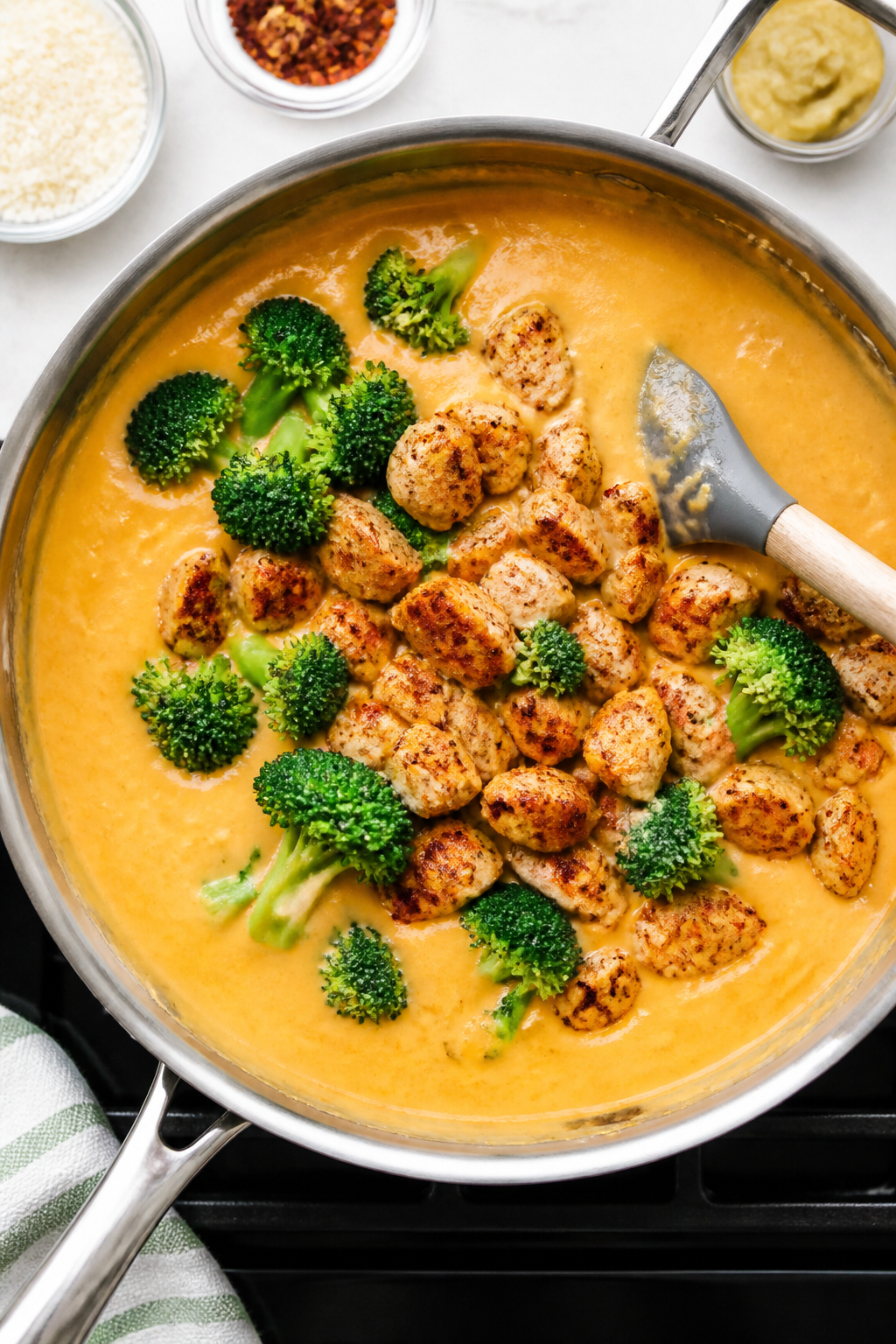 Cooking process: Overhead shot of the cheesy sauce stage in a large skillet—smooth, glossy cheese 