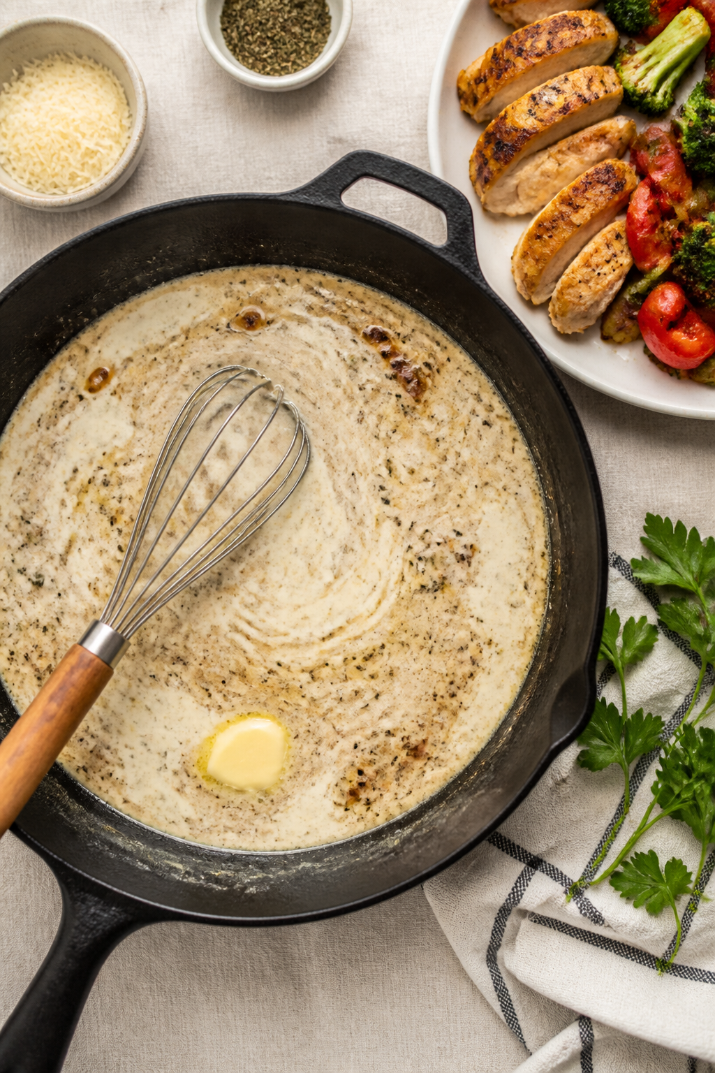 Cooking process: Overhead shot of the sauce-building stage in the same skillet—cream cheese whiske