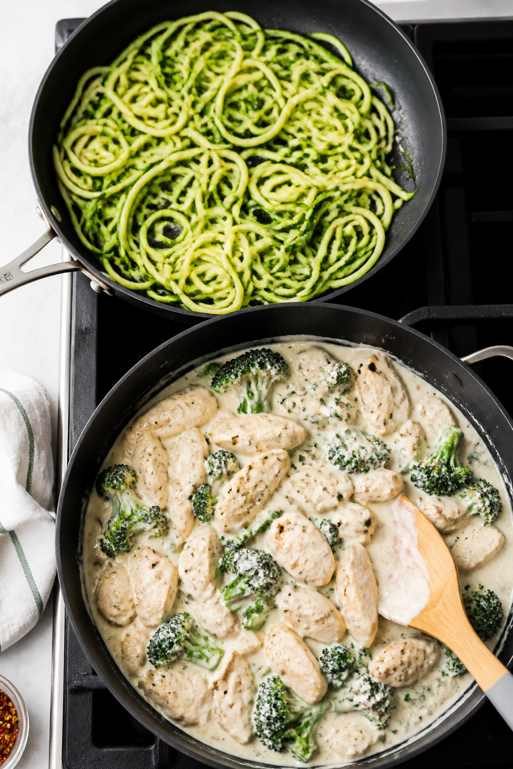 Cooking process: Overhead shot of zucchini noodles being quickly sautéed in a separate skillet unti