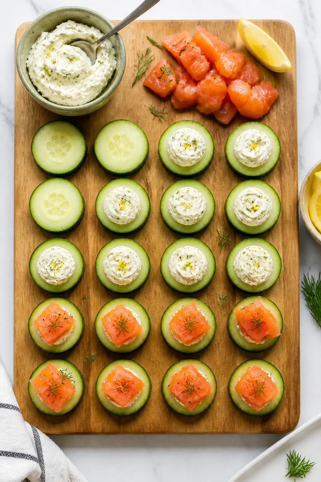 Cooking process: Assembling Keto Salmon Cucumber Bites on a clean board—thick, pre-sliced cucumber